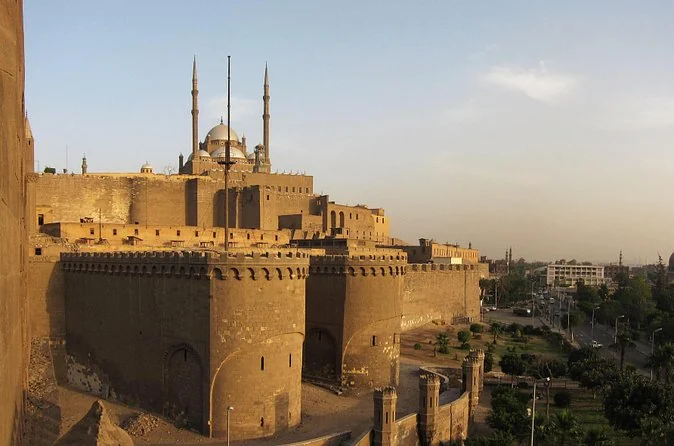 The walls of the Citadel and the Muhammad Ali Mosque glowing in low sunset light